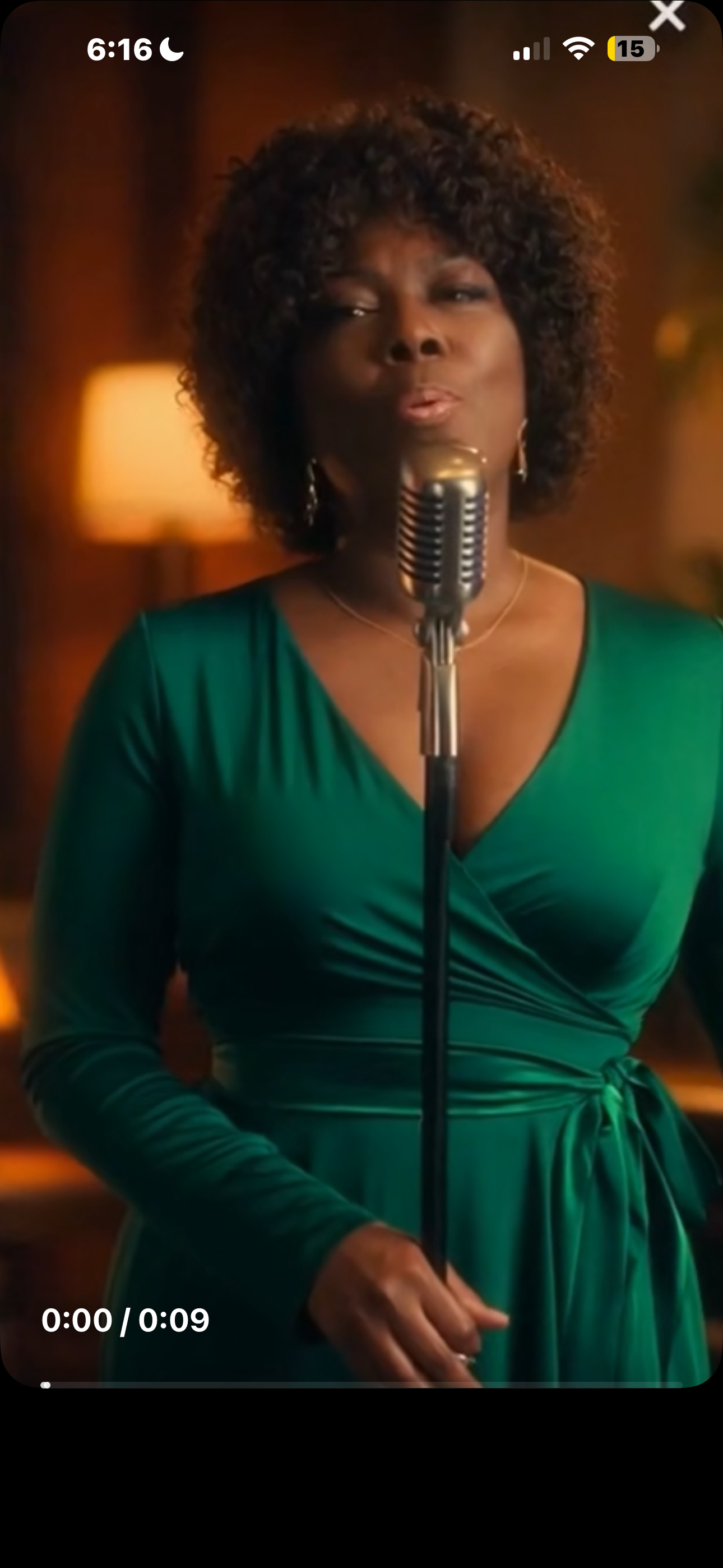 Diann Shumate, Phoenix jazz singer, performing in an emerald green dress at a vintage microphone.