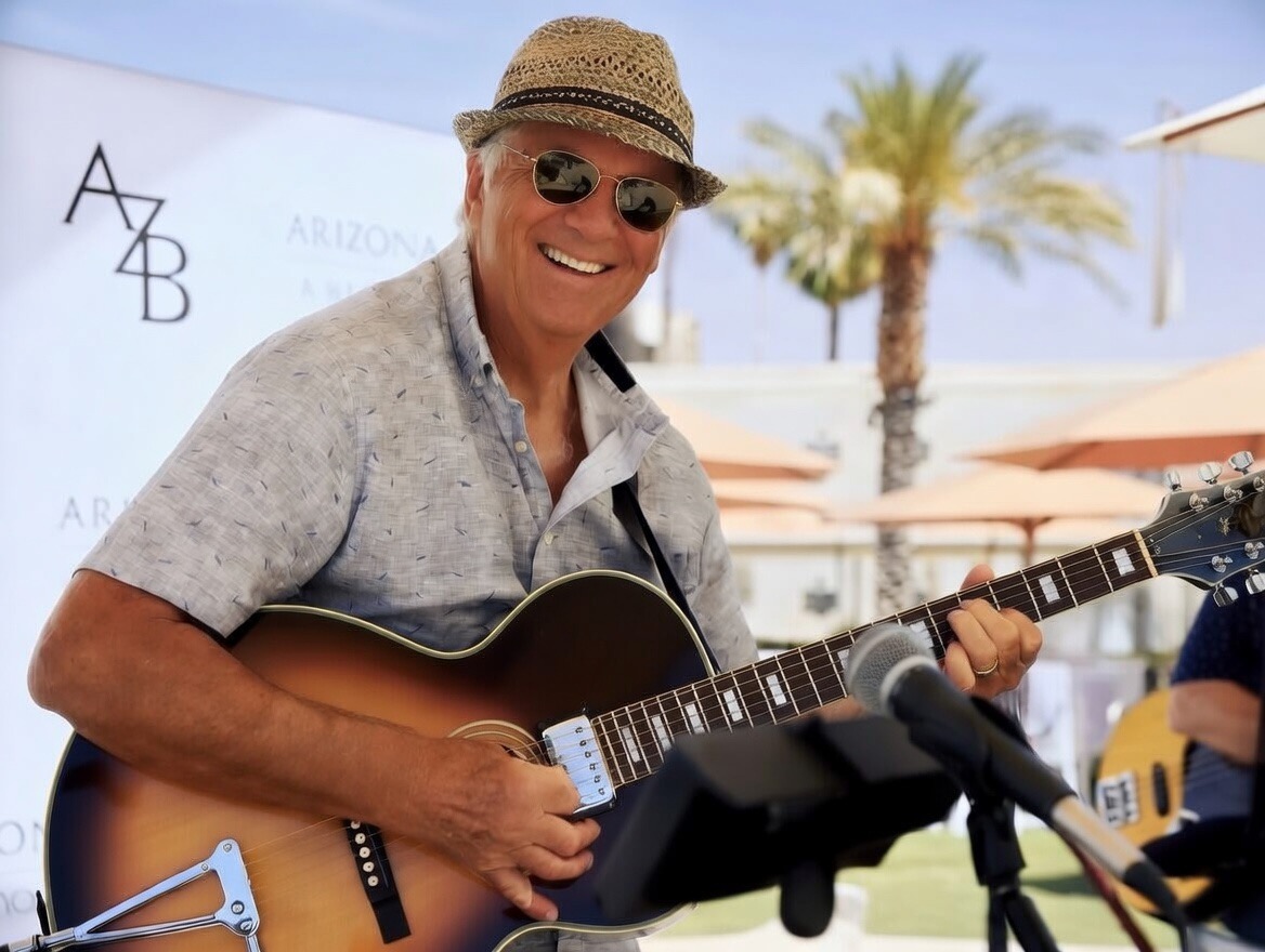 RichMo Brown, Phoenix jazz guitarist, performing live outdoors.